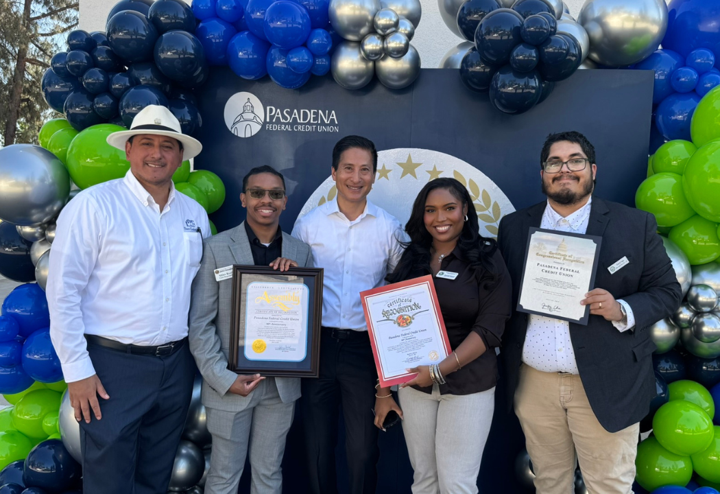 Pasadena FCU employees standing together and holding up awards.